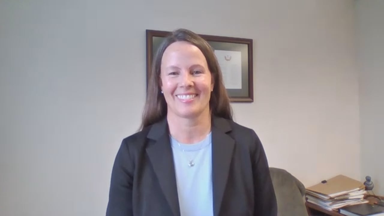 A woman in a suit jacket.