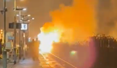 Flames erupt and black smoke fills night sky in huge blaze on train line