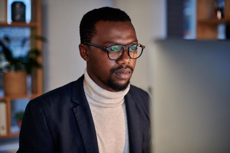 Black male millenial manager working on AI innovation fir his team