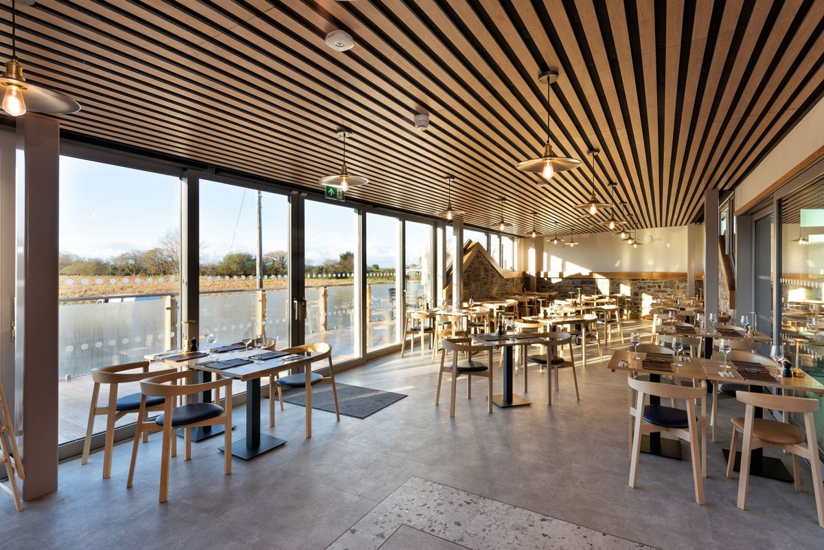 The restaurant includes a change in floor covering where the pig sty walls used to be at The renovation, conversion and transformation of T'yn Llan commnity pub in Llandwrog, Gwynedd this is the new build extension with restaurant, catering kitchen, facilities and community room