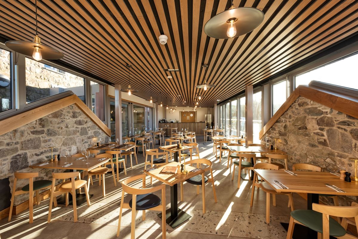 The restaurant also includes stone walls that mimic where the pig sty's gable end roof lines once were at The renovation, conversion and transformation of T'yn Llan commnity pub in Llandwrog, Gwynedd this is the new build extension with restaurant, catering kitchen, facilities and community room