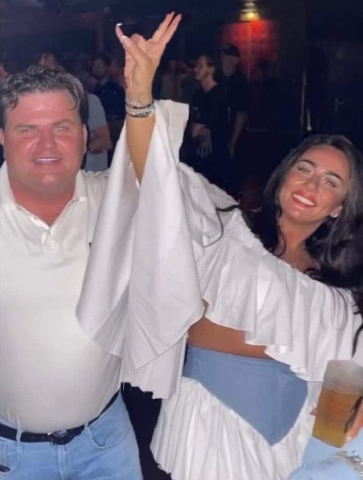 Thomas Casey smiling and dancing next to woman