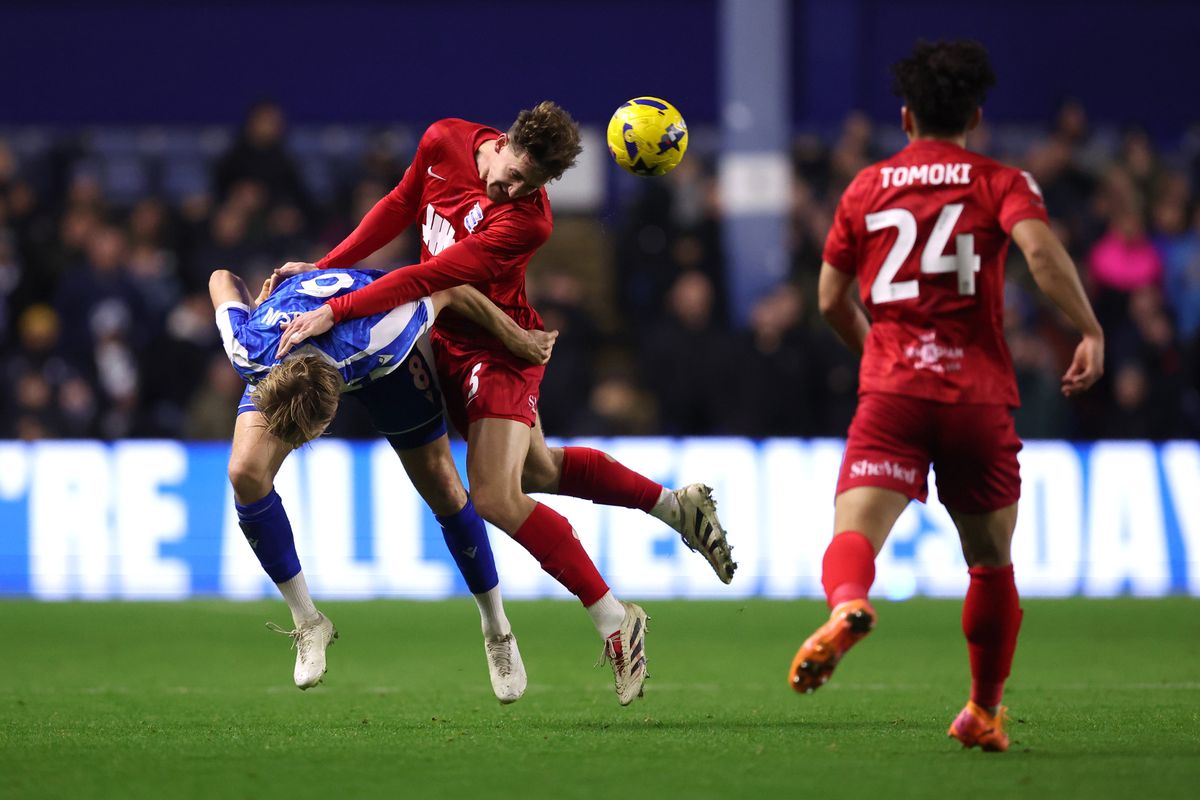 Phil Neumann of Birmingham City battles for a header with Svante Ingelsson of Sheffield Wednesday