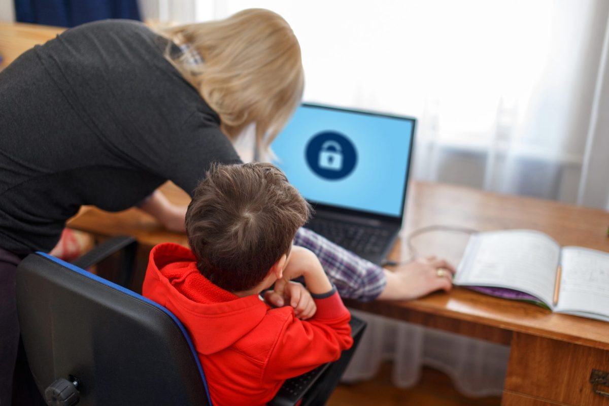 Child on computer with mother