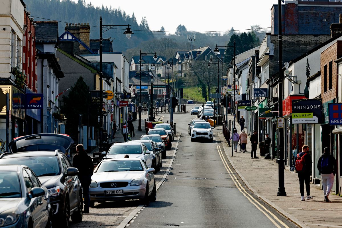 A street on a hill with cars