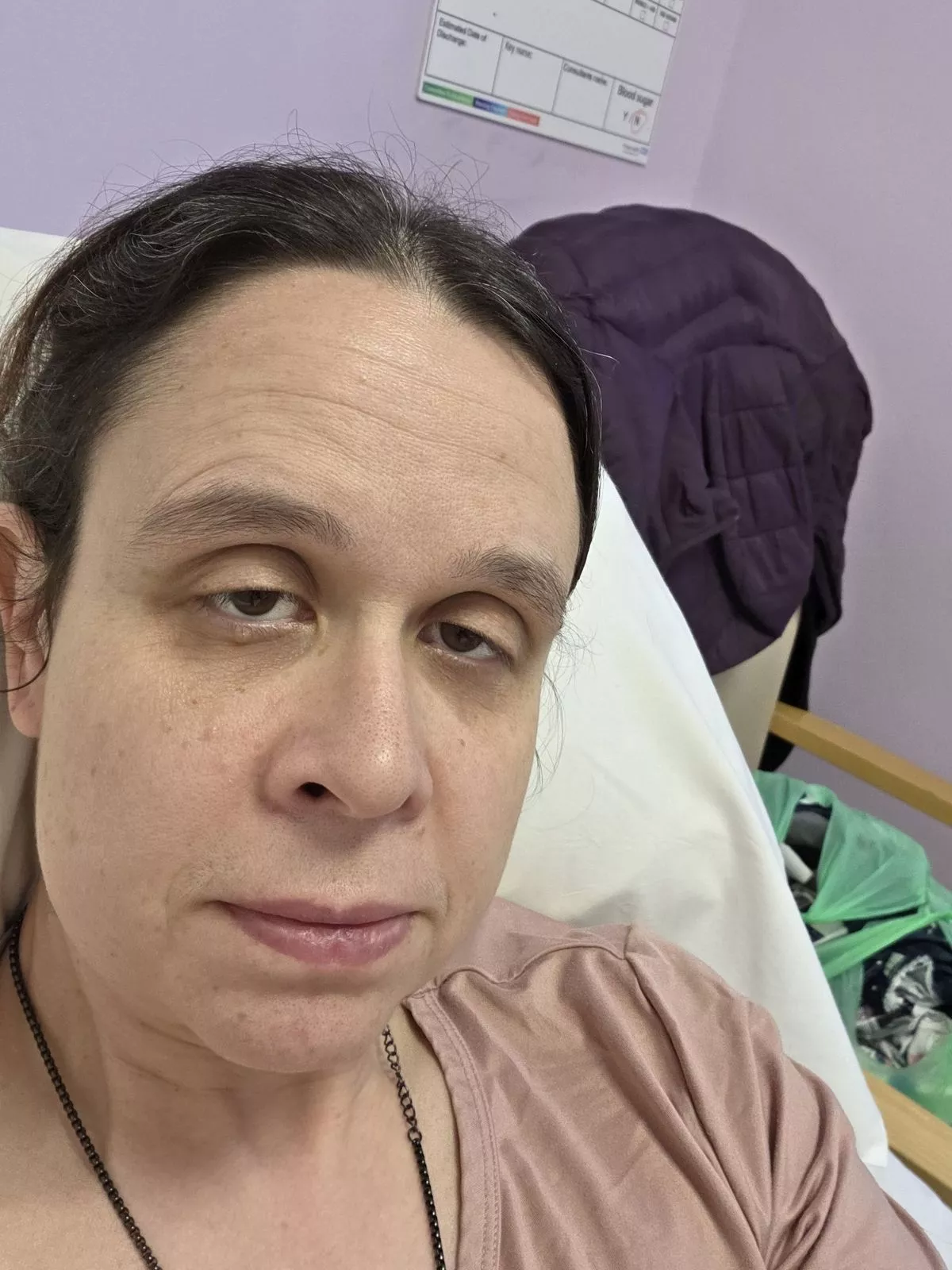 Clare Garrett looking unwell in hospital after the scan