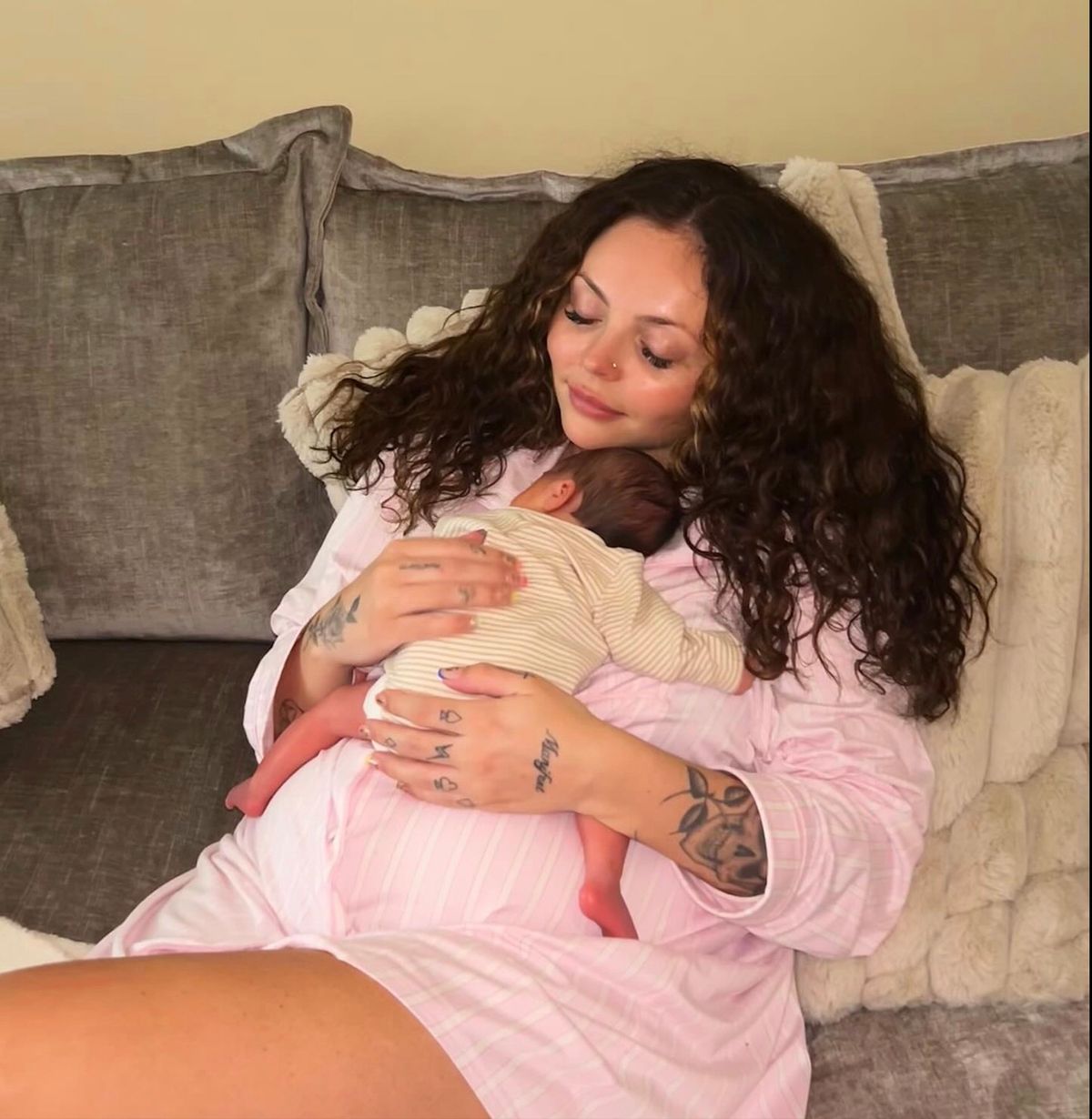 Jesy Nelson cradling one of her baby daughters