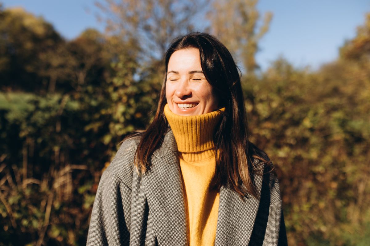 A woman in sunlight, smiling