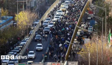 Iranian shopkeepers and traders protest next to a highway in Tehran on 29 December.
