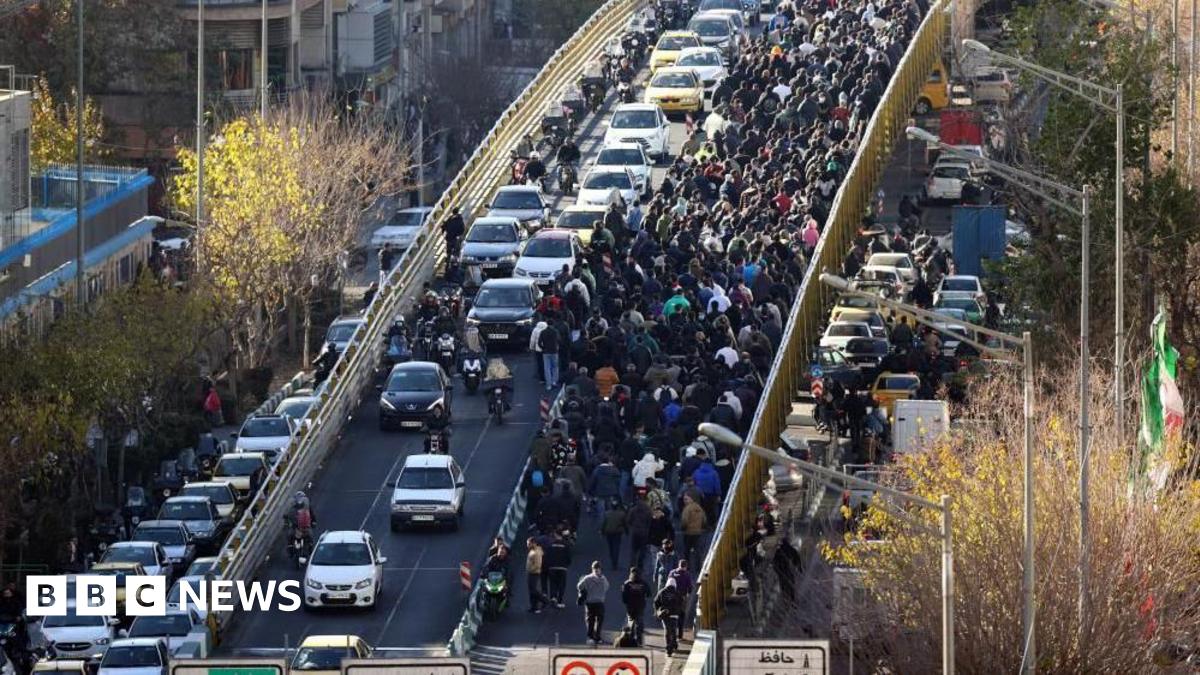 Iranian shopkeepers and traders protest next to a highway in Tehran on 29 December.