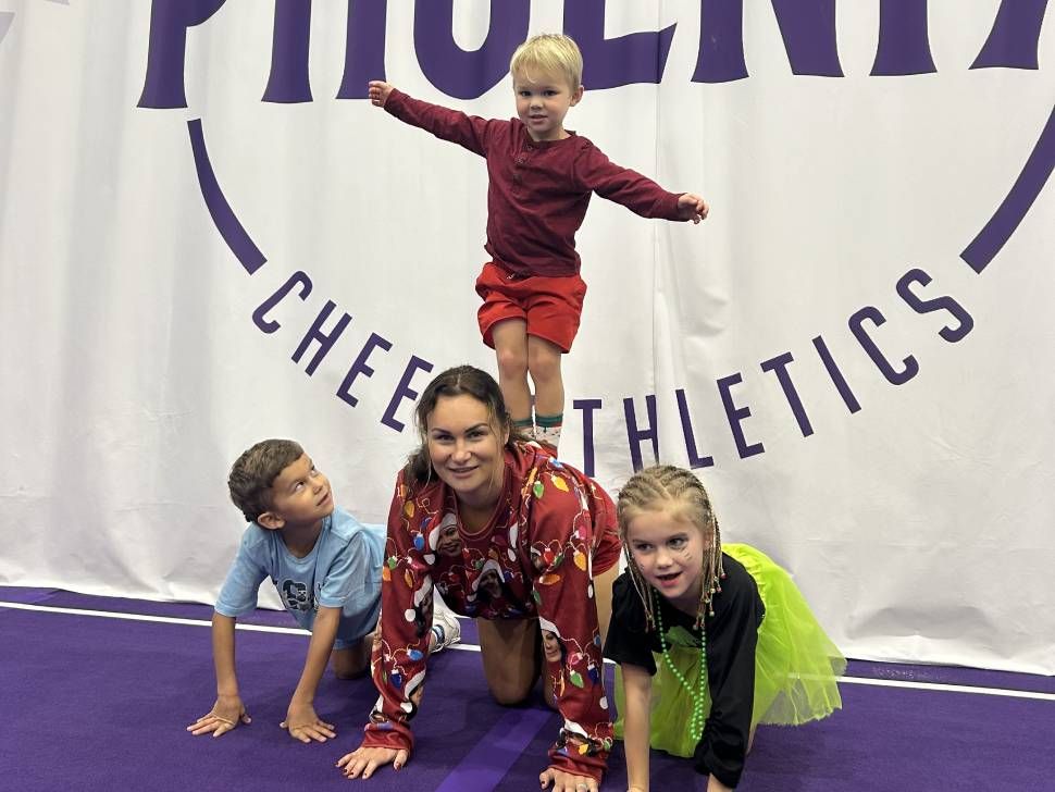 Kids and their mom doing a pyramid in a gym (GW)