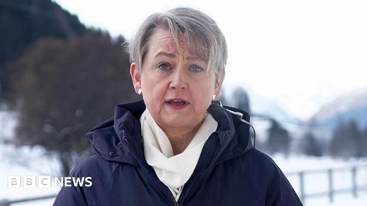 Yvette Cooper speaking to BBC Breakfast from Davos, in Switzerland dressed in a blue winter coat and white scarf, against a snowy backdrop