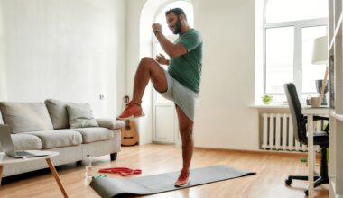 man wearing tshirt and shorts exercising in a living room setting standing on an exercise mat performing high knee to opposite elbow move.