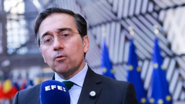Spanish Foreign Affairs Minister Jose Manuel Albares speaks to reporters outside an EU council meeting