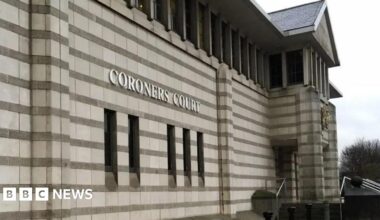 An image of the exterior of Doncaster Coroner's Court. It has stonework with horizontal stripes, and a crest above the entrance