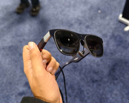 a person holding Xreal 1S AR glasses