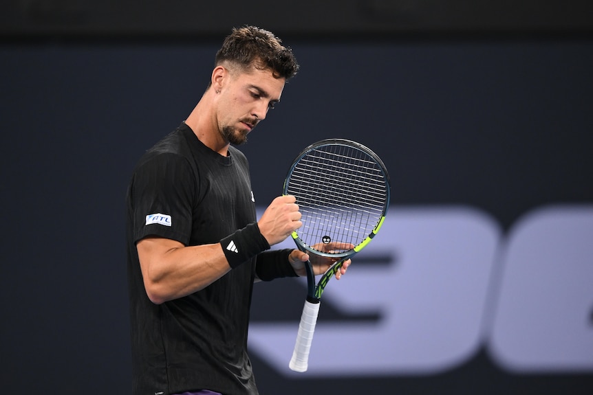 Thanasi Kokkinakis smiles and clenches his fist