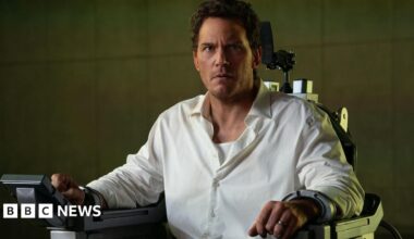 Chris Pratt locked in an executioner's chair, he's in a white shirt and looks very concerned
