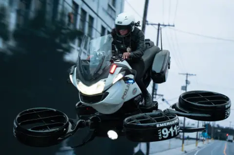 2025 Amazon Content Services LLC Kali Reis riding a futuristic police bike, which flies 