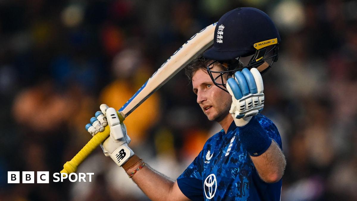 Joe Root raises his bat and helmet after reaching his hundred against Sri Lanka