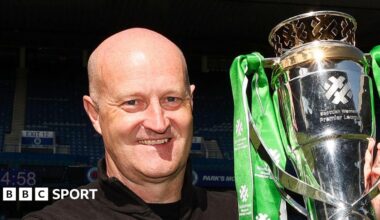 Hibernian Head Coach Grant Scott lifts the Scottish Women's Premier League trophy during a Scottish Women's Premier League match between Rangers and Hibernian at Ibrox Stadium,