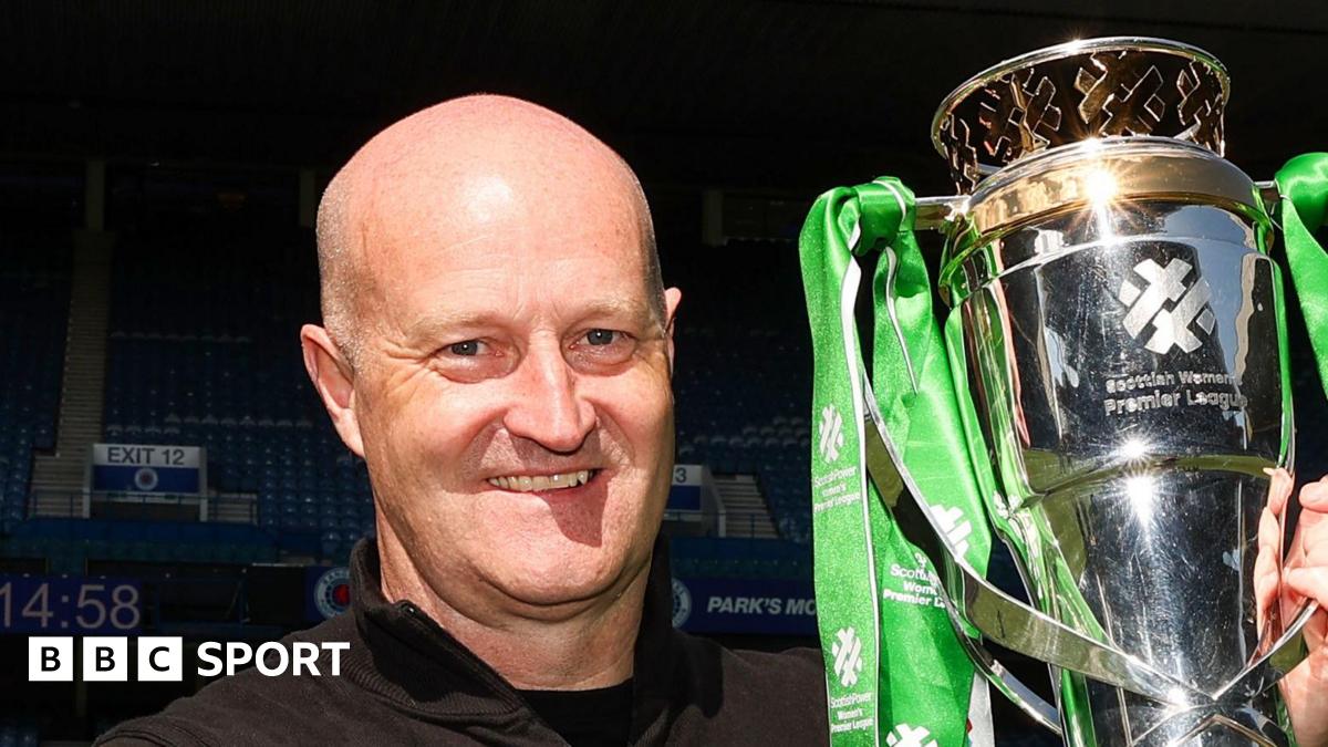 Hibernian Head Coach Grant Scott lifts the Scottish Women's Premier League trophy during a Scottish Women's Premier League match between Rangers and Hibernian at Ibrox Stadium,