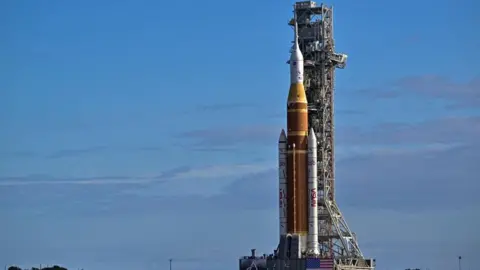Reuters An image of a mega rocket in a stable position, surrounded by blue skies, before it was rolled towards the Kennedy Space Center in Cape Canaveral, Florida.