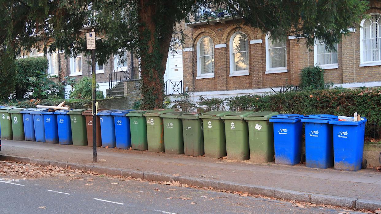 Multiple wheelie-bins outside Victorian houses on Camberwell Grove, London, UK. London borough of Southwark.