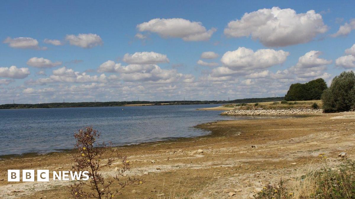 A large reservoir of water with long, dry banks around the edges.