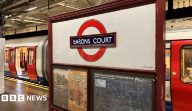 Barons Court Tube roundel with Tube train in background