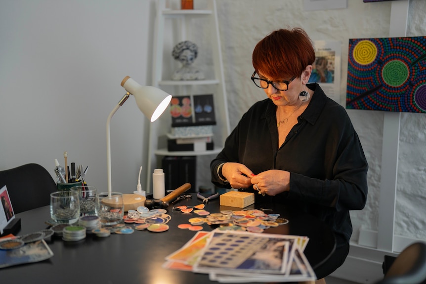 Woman in studio working on earrings
