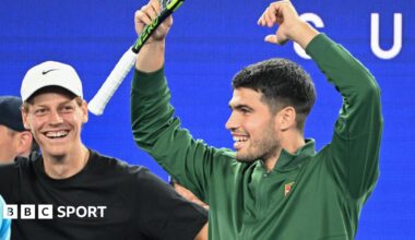 Jannik Sinner and Carlos Alcaraz watch on at the Australian Open