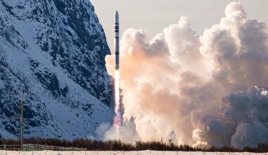 a black and white rocket launches with a snow-covered mountain in the background