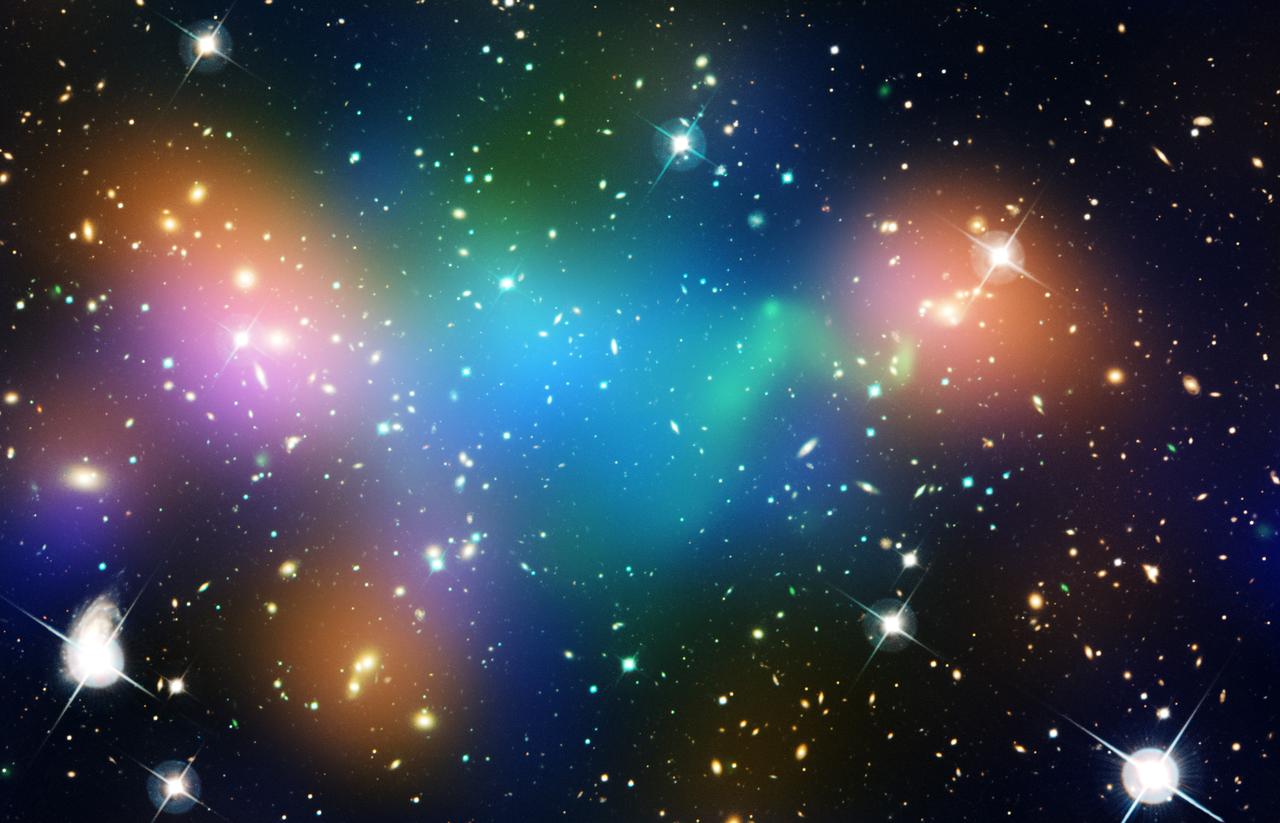 Image of bright white stars surrounded by clouds of bright colors against a black background.