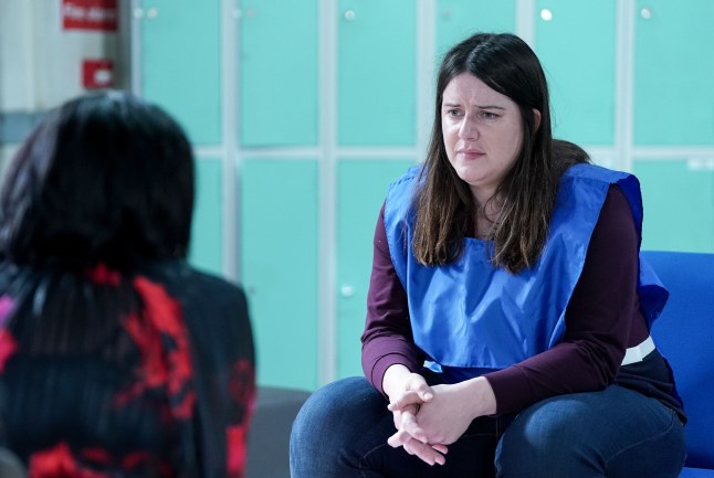 Zoe facing Kat in the prison visiting room in EastEnders