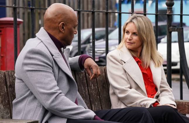 George Knight and Sam Mitchell talking on a bench in EastEnders