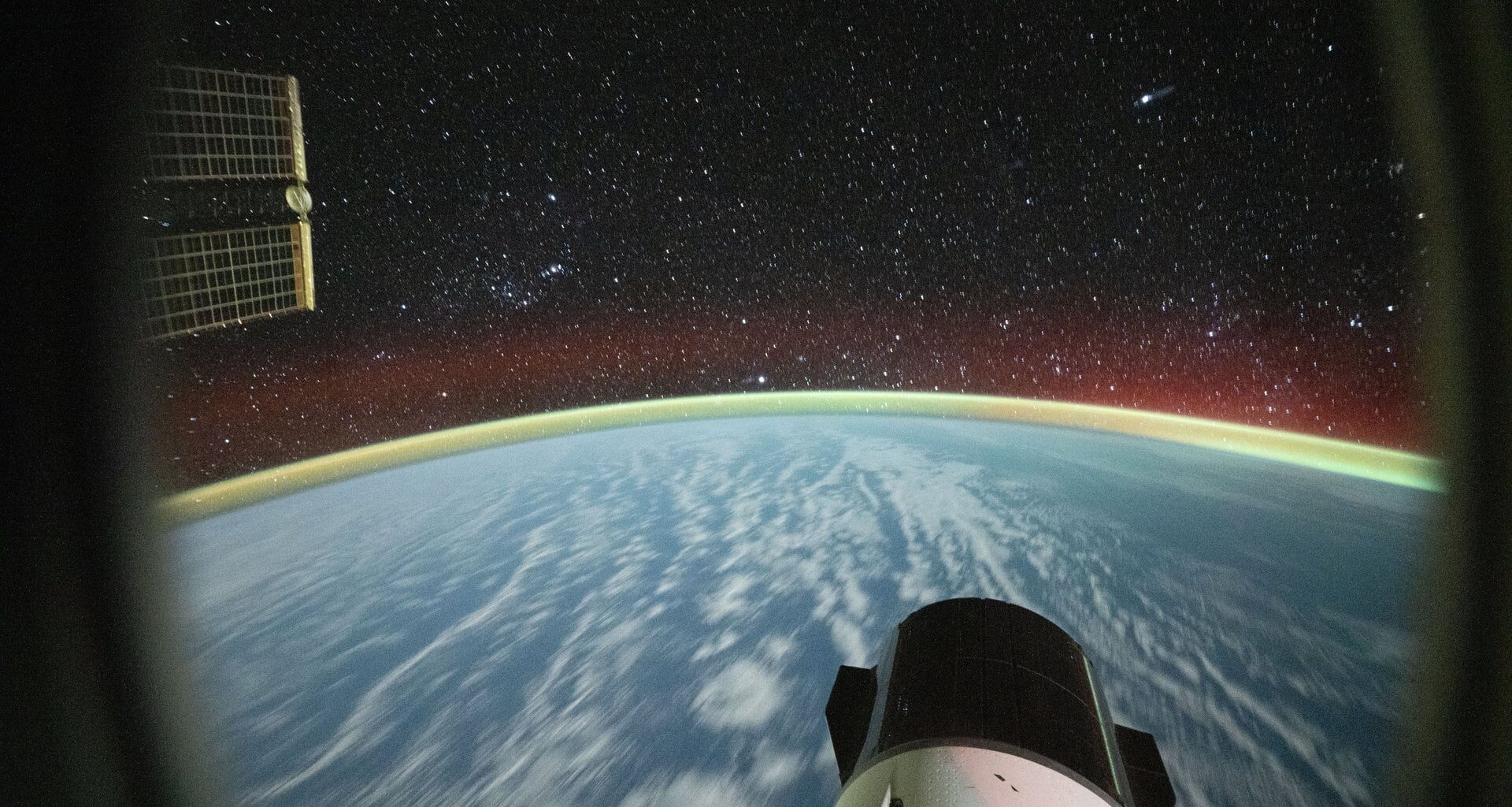 Long-exposure photograph from the International Space Station with a SpaceX Dragon cargo spacecraft visible in the lower foreground. Credit: NASA