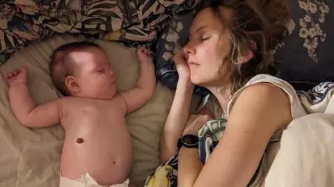 BBC Louise asleep next to her baby, who is also asleep