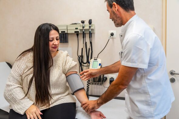 Doctor measures patient's blood pressure Doctor measures patient's blood pressure