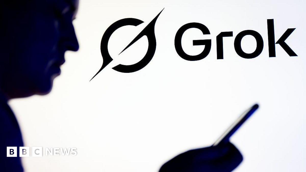 The logo of Grok in the background alongside a silhouette of a man holding and looking at a mobile phone.