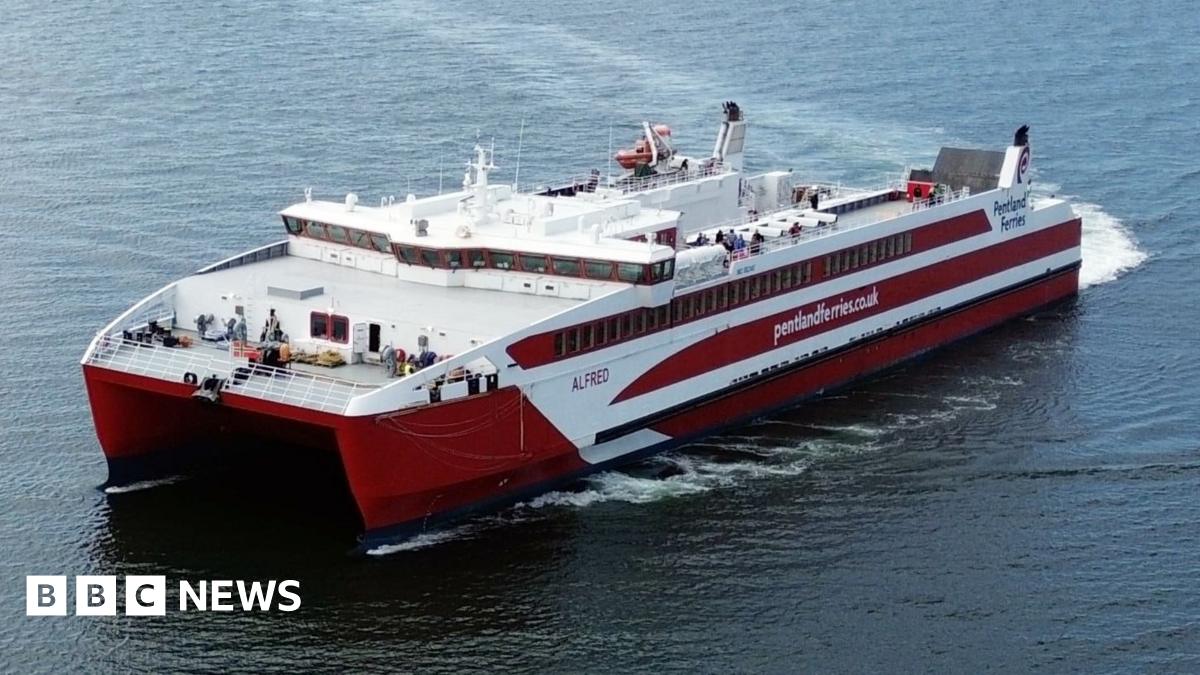 A red and white catamaran ferry with Pentland Ferries written on the side