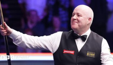 John Higgins celebrates