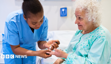A graphic design of red, black and cream, with arrows, a pound sign and a hand holding three credit cards.