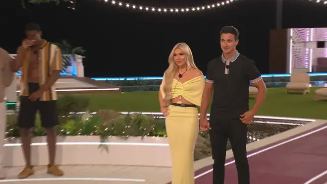 Tommy and Lucy pictured holding hands at the fire pit.