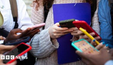 Hands of teenage girls on mobile phones