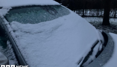 A car windscreen covered in snow