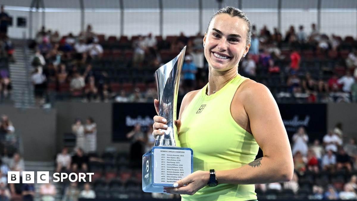Aryna Sabalenka holds the trophy after winning the Brisbane International