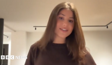 Charlotte Niddam poses in a brown t-shirt