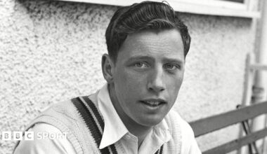 A black and white picture of Norman Gifford sitting outside the pavillion at New Road