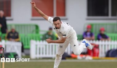 Matt Taylor bends over while standing on one leg as he bowls during a County Championship match in 2025